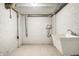 Unfinished basement featuring white brick walls, concrete floors, and a white utility sink at 4904 N Washington Blvd, Indianapolis, IN 46205