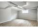 Finished basement featuring white painted brick walls, a window, and light colored woodgrain floors at 4904 N Washington Blvd, Indianapolis, IN 46205