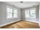 Bedroom with hardwood floors and two windows providing natural light and neighborhood views at 4904 N Washington Blvd, Indianapolis, IN 46205