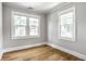 Bedroom with hardwood floors and two windows providing natural light and neighborhood views at 4904 N Washington Blvd, Indianapolis, IN 46205