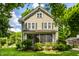 Charming two-story home with a landscaped front yard and a screened in porch at 4904 N Washington Blvd, Indianapolis, IN 46205