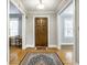 Classic foyer with hardwood floors, a decorative rug, and neutral paint at 4904 N Washington Blvd, Indianapolis, IN 46205