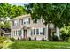 Charming two-story home with a well-manicured lawn and lush landscaping at 4904 N Washington Blvd, Indianapolis, IN 46205