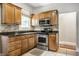 Close up of kitchen area with stainless steel stove and oven, plus wood cabinets at 4904 N Washington Blvd, Indianapolis, IN 46205