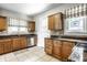 Kitchen featuring granite countertops, wood cabinets, and tile flooring and backsplash at 4904 N Washington Blvd, Indianapolis, IN 46205