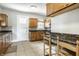 Cozy kitchen with brown cabinets, tile backsplash, and a breakfast bar at 4904 N Washington Blvd, Indianapolis, IN 46205