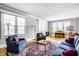 Inviting living room with hardwood floors, piano and neutral paint at 4904 N Washington Blvd, Indianapolis, IN 46205
