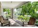 Screened in porch with a light colored ceiling and featuring chairs overlooking the front yard at 4904 N Washington Blvd, Indianapolis, IN 46205