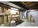 Unfinished basement with wooden workbench and industrial utility equipment at 5240 Windridge Dr, Indianapolis, IN 46226