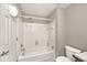 Bright bathroom featuring a tub with white tiled walls and standard toilet at 5240 Windridge Dr, Indianapolis, IN 46226