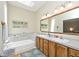 Bathroom features a large mirror, double vanity, and tub at 5240 Windridge Dr, Indianapolis, IN 46226