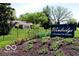 Community sign 'Windridge Condominium Homes' with well-maintained landscaping and partial view of homes at 5240 Windridge Dr, Indianapolis, IN 46226