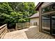 Spacious wooden deck surrounded by lush greenery and connected to the home's exterior at 5240 Windridge Dr, Indianapolis, IN 46226