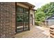 Wooden deck with large windows offering a view of the surrounding trees and greenery at 5240 Windridge Dr, Indianapolis, IN 46226