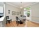 Bright dining area with hardwood floors, chandelier, and a table set with checkered tablecloth at 5240 Windridge Dr, Indianapolis, IN 46226