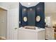 Charming entryway nook with navy blue walls, decorative art, and an adjacent door at 5240 Windridge Dr, Indianapolis, IN 46226