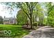 View of the home's grounds, showcasing lush greenery and mature trees at 5240 Windridge Dr, Indianapolis, IN 46226