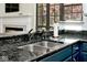 Close-up of the kitchen sink with granite countertops and updated fixtures at 5240 Windridge Dr, Indianapolis, IN 46226