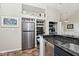 Well-equipped kitchen with stainless steel refrigerator, granite counters, and built-in microwave at 5240 Windridge Dr, Indianapolis, IN 46226
