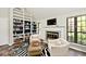 Bright living room featuring a fireplace, built-in bookshelves, and natural light at 5240 Windridge Dr, Indianapolis, IN 46226