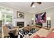 Bright living room features large windows, hardwood floors, a fireplace, and designer furnishings at 5240 Windridge Dr, Indianapolis, IN 46226