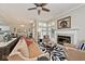 Open concept living room with fireplace, zebra rug, lots of windows and adjoined to the dining area at 5240 Windridge Dr, Indianapolis, IN 46226