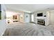 Spacious living room featuring neutral carpet, fireplace, and natural light at 5240 Windridge Dr, Indianapolis, IN 46226