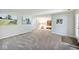 Large living room with wall art and natural light streaming through door and windows at 5240 Windridge Dr, Indianapolis, IN 46226