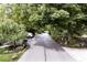 Street view featuring a landscaped parkway with tall trees and a glimpse of a parked car at 5240 Windridge Dr, Indianapolis, IN 46226