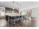 Open kitchen with dark wood cabinets, granite countertops, stainless steel appliances, and bar stool seating at 5363 Citadel Dr, Noblesville, IN 46062