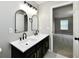 Bathroom featuring a double vanity with sleek black fixtures and access to an adjacent bedroom at 5759 Columbia S Cir, Greenwood, IN 46142