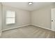 Bedroom with plush gray carpeting, a window providing natural light, and a clean, neutral color scheme at 5759 Columbia S Cir, Greenwood, IN 46142