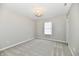 Cozy bedroom with soft gray carpet, window, and a modern light fixture enhancing the inviting space at 5759 Columbia S Cir, Greenwood, IN 46142