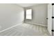 Bedroom featuring plush gray carpeting, a window for natural light, and neutral-toned walls at 5759 Columbia S Cir, Greenwood, IN 46142