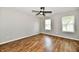 Bright bedroom with hardwood floors, ceiling fan, and natural light from two windows at 5759 Columbia S Cir, Greenwood, IN 46142