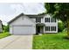 Charming two-story home featuring a two-car garage, green lawn, and classic architectural design at 5759 Columbia S Cir, Greenwood, IN 46142
