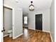 Hallway with wood-look floors and a nearby bathroom and black interior doors at 5759 Columbia S Cir, Greenwood, IN 46142