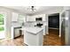 Modern kitchen featuring white cabinets, stainless steel appliances, and an island with quartz countertop at 5759 Columbia S Cir, Greenwood, IN 46142