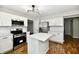 Modern kitchen with stainless steel appliances, island, white cabinetry, and stylish light fixture at 5759 Columbia S Cir, Greenwood, IN 46142