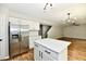 Open kitchen view features a stainless steel refrigerator, center island and flows into living area at 5759 Columbia S Cir, Greenwood, IN 46142