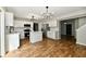 Bright kitchen with white cabinetry, stainless steel appliances, island, and hardwood flooring at 5759 Columbia S Cir, Greenwood, IN 46142