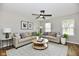 Cozy living room featuring neutral-toned sofas, area rug, and abundant natural light through multiple windows at 5759 Columbia S Cir, Greenwood, IN 46142