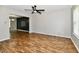 Bright living room with hardwood floors, modern ceiling fan and stylish wall paneling in dining area at 5759 Columbia S Cir, Greenwood, IN 46142