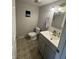 Bathroom with modern vanity, neutral wall paint, and tiled floors at 6027 Moonseed Cir, Indianapolis, IN 46203