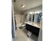 Bright bathroom with a vanity featuring a marble countertop, framed mirror, and a shower-tub combo at 6027 Moonseed Cir, Indianapolis, IN 46203