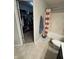 Cozy bathroom featuring a shower, tub, and a walk-in closet with ample storage space at 6027 Moonseed Cir, Indianapolis, IN 46203