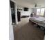 Large bedroom boasting a ceiling fan, carpeted floors, and a picturesque view through the window at 6027 Moonseed Cir, Indianapolis, IN 46203