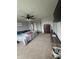 Spacious bedroom featuring a ceiling fan, carpeted floors, and a large bed with grey-painted walls at 6027 Moonseed Cir, Indianapolis, IN 46203