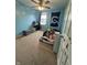 Carpeted bedroom with playful blue walls, a fan, and closet space; perfect for a sanctuary at 6027 Moonseed Cir, Indianapolis, IN 46203