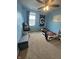 Charming bedroom with blue walls, carpeted floors, and playful decor, illuminated by natural light at 6027 Moonseed Cir, Indianapolis, IN 46203